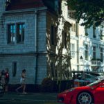 a red sports car parked on the side of a street